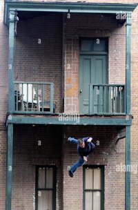 stunt-man-falling-from-an-upstairs-balcony-on-a-movie-film-set-universal-B7KT3H.jpg